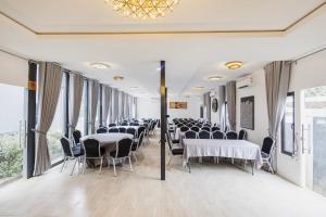 a banquet hall with tables and chairs and windows at Aduke's Residence Abuja in Abuja