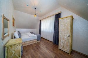 a bedroom with a bed and an open door at Quba Qala Resort in Quba +34 photos