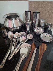 a bunch of kitchen utensils sitting on a counter at SITER Holidays Villa in Kovalam +24 photos
