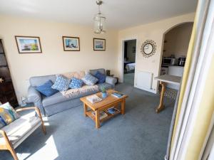 a living room with a couch and a table at Idyllic, Luxurious Seaside Flat for 4. in Borth +7 photos