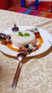 a plate of food with rice on a table at Luxury Camp Sahara in Merzouga +35 photos