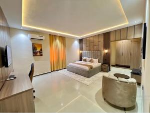 a hotel room with a bed and a couch at Rivona Hotels & Suites in Uyo
