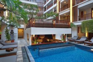 a swimming pool in the middle of a building at The Magani Hotel and Spa in Legian