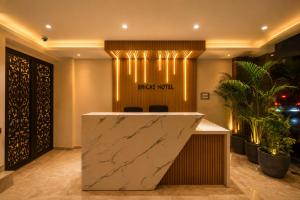 a lobby with a marble counter and a back yard sign at Hotel Bricks, Karol Bagh, New Delhi in New Delhi