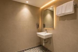 a bathroom with a sink and a mirror at Hotel Bricks, Karol Bagh, New Delhi in New Delhi +45 photos