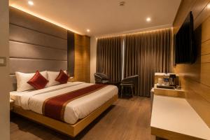 a hotel room with a bed and a television at Hotel Bricks, Karol Bagh, New Delhi in New Delhi