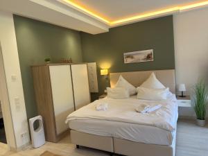 a bedroom with a large bed with white pillows at Strand FeWo Rügen Baltic Sea in Binz