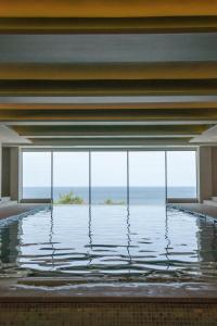 a swimming pool with a view of the ocean at THE NICI Newquay in Newquay
