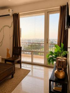 a living room with a large window with a view at 5 Mins from Prem Mandir 1 BHK Apartment in Vrindāvan