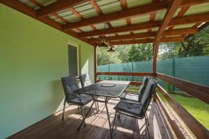 a patio with a table and chairs on a deck at NATALiHAUS in Děčín