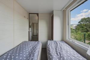 a bedroom with a bed and a window at NATALiHAUS in Děčín