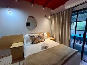 a bedroom with a large bed and a mirror at Bloem Spa Hotel & Conference in Bloemfontein +24 photos