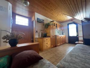 a bedroom with a bed and a wooden ceiling at Bohinj Nook Apartment in Bohinj
