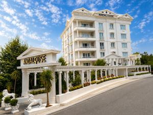 a large white building with neoclassical architecture and statues at Andalouse Otel in Trabzon +38 photos