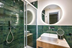 a bathroom with a sink and a shower with a mirror at Istedda Boutique Hotel in Villasimius