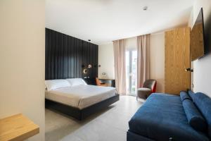 a hotel room with a bed and a couch at Istedda Boutique Hotel in Villasimius