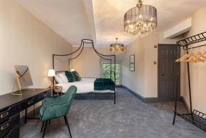 a bedroom with a bed and a desk and a chair at Marske Hall, Yorkshire Dales in Marske