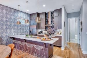 a kitchen with a large island in the middle at Rooftop Deck & Shuffleboard BBQ Near Downtown in Nashville