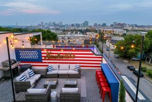 an american flag on the roof of a building at Rooftop Deck & Shuffleboard BBQ Near Downtown in Nashville