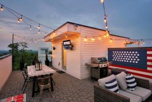 an outdoor patio with a grill with an american flag at Rooftop Deck & Shuffleboard BBQ Near Downtown in Nashville