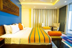 a bedroom with a large bed and a blue wall at A'lanka luxury hotel in haputale in Walhaputenna +20 photos
