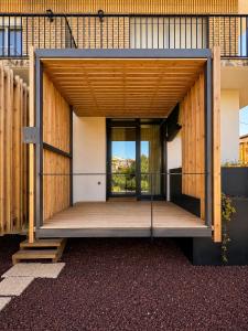 an open door of a building with a wooden deck at Los ojos del Alai in Labastida