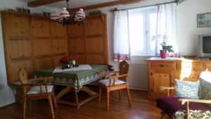 a dining room with a table and chairs and a window at Haus Lerchenreith in Bad Aussee