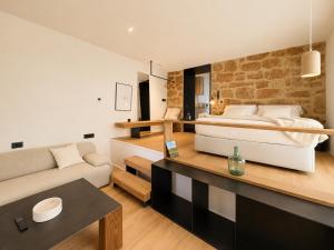 a bedroom with a bed and a living room at Los ojos del Alai in Labastida
