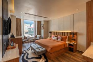 a hotel room with a bed and a living room at Perfectstayz Premium Mahadev Regency in Katra