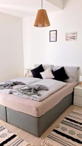 a large bed in a room with at Helikon Terasz Apartman in Keszthely
