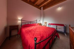 a bedroom with a red bed in a room at Tenuta Giave - nel cuore dell'Irpinia in Montemarano +22 photos
