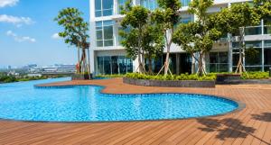 a swimming pool in front of a building at Modern studio with a stûnning view at 32 floor in Jakarta