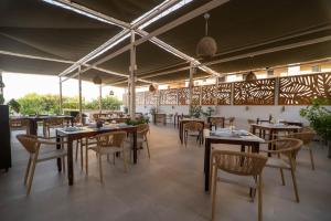 a restaurant with tables and chairs in a room at Elena Beach Hotel in Kissamos