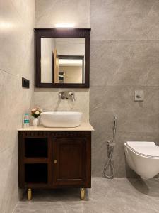 a bathroom with a sink and a toilet and a mirror at Grand Valley - A Boutique Resort in Mount Abu in Mount Ābu +31 photos