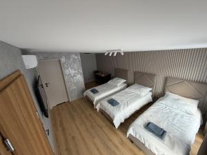 a room with two beds in a room at Sunrise Apartamenty in Chocicza