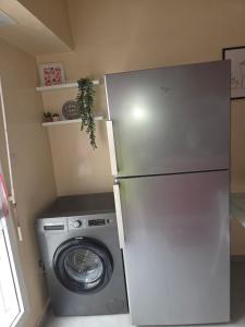 a refrigerator and a washing machine in a kitchen at Dar mayssane in Agadir