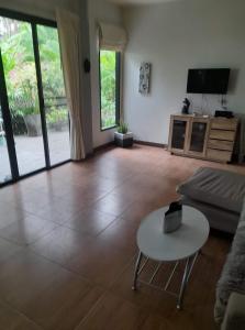 a living room with a couch and a table at Palm Oasis in Nathon Bay