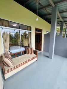 a living room with a couch and a chair at Liana Guest House Ella in Ella