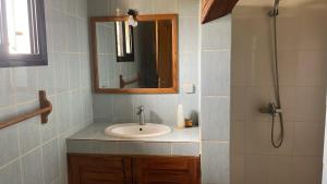 a bathroom with a sink and a mirror and a shower at Villa 4 in Saly Portudal +23 photos