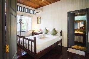 a bedroom with a large bed in a room at Baan Noppawong in Bangkok