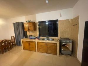 a kitchen with a sink and a stove top oven at Villa 4 in Saly Portudal