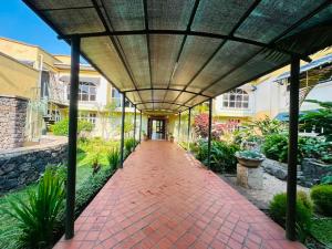 a brick walkway leading to a building at Ikoro Hotel in Kisoro +6 photos