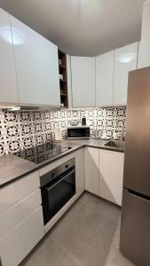 a kitchen with white cabinets and a stove top oven at Studio 13 Warsaw in Warsaw