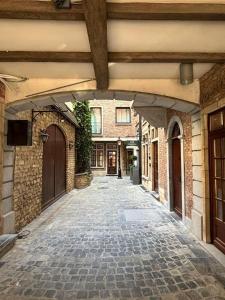 an empty alley with a building in the background at Georges Henri Aparthotel in Brussels