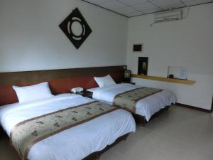 A bed or beds in a room at 池上福吉園素食民宿 臺東縣民宿073號 請勿透過阿勾達訂房