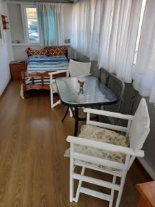 a room with a table and chairs and a bed at Little Paradise Livadi Himare in Himare +16 photos