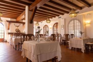 a dining room with tables and chairs in a building at Hotel Tugasa Villa de Algar in Algar
