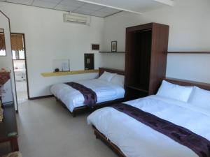 A bed or beds in a room at 池上福吉園素食民宿 臺東縣民宿073號 請勿透過阿勾達訂房