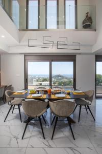 a dining room with a table and chairs at Aetheria Luxury Villa in Kalithies