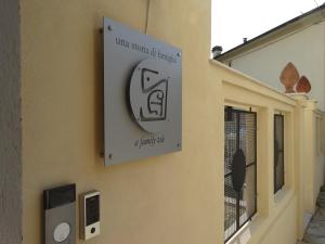 a sign on the side of a building at A Family Tale - Una Storia Di Famiglia in Monterchi